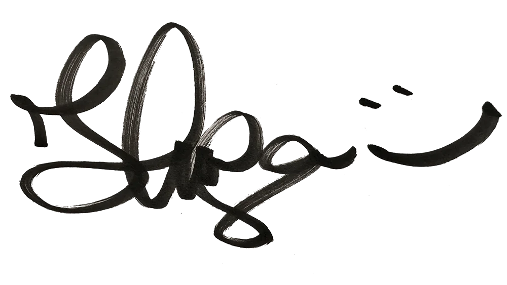 Kinga's Signature written with a thick black sharpie pen on a white sheet